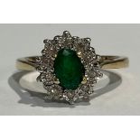 A 9ct gold diamond and emerald ring, boxed