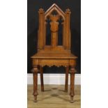 A late Victorian Gothic Revival oak hall chair, 92.5cm high, 45.5cm wide, the seat 32cm deep