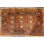 An Antique Oriental rug, 149 cm x 93cm.