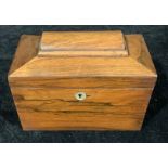 A Victorian rosewood sarcophagus tea caddy, hinged cover enclosing a pair of lidded compartments,