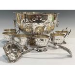 A silver plated pedestal punch bowl, embossed with floral swags, lion mask handles, with ladle and