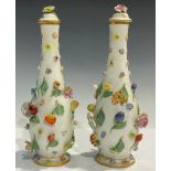 A pair of Meissen elongated ovoid vases and covers, each encrusted with flowers and fruit, flower