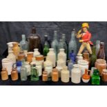 A collection of 19th century and later advertising glass bottles and stoneware jars, etc; a