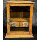 An Edwardian oak smoker's cabinet, glazed door, fitted with two drawers, key