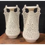 A pair of Graingers Worcester reticulated spreading ovoid vases, in the white, with Persian inspired