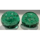 A pair of Victorian green glass dumps, flower inclusions, 8.5 / 9cm c. 1880