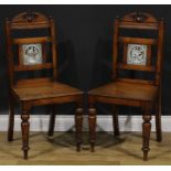 A pair of late Victorian tile back oak hall chairs, of Shakespearean interest, the Shakespeare