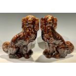 A pair of Victorian Staffordshire treacle glazed mantel dogs, 28.5cm high