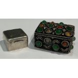 A silver coloured metal stamp case; an Indian silver coloured metal bejewelled box (2)