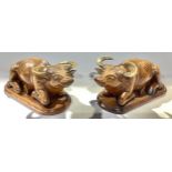 A pair of Indian carved hardwood water bison, horn horns and bone eyes, integral bases, mid-20th