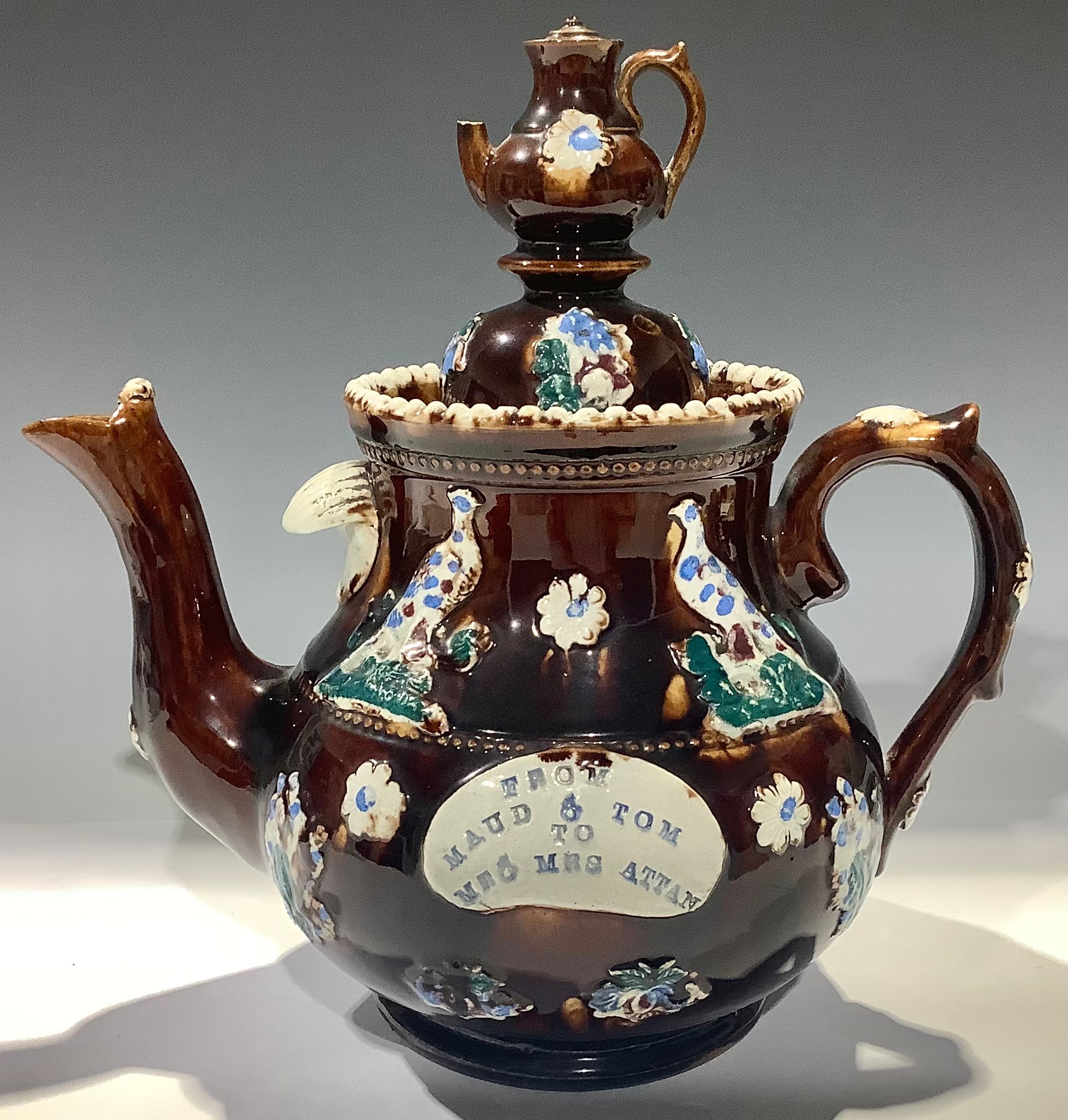 A late 19th century barge ware teapot, treacle glaze, "From Maud and Tom to Mr and Mrs Attan", domed