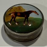 A silver and enamel box, hinged cover decorated with a horse and jockey