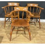 A harlequin set of three beech and elm smoker’s bow elbow chairs, ±81.5cm high, 67.5cm wide, the