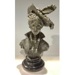 A dark patinated bronze bust, lady of fashion with stylised collar and feathered hat, black marble