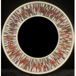 A Piaggi Roulette circular looking glass, the central mirror plate framed by a multicoloured