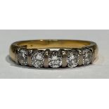 An 18ct gold five stone diamond ring, set with five brilliant cut stones, each approx. 3mm, size M/