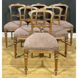 A set of six Victorian walnut dining chairs, each cresting rail carved with a stylised palmette, the
