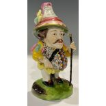 A Samson porcelain type Mansion House Dwarf, standing on shaped circular base holding a staff,