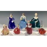 A Royal Doulton figure, First Bloom HN 3913; others, Janine HN 2461; Helen HN 3601; Best Wishes HN