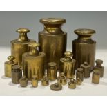 A set of early 20th century graduated brass continental metric weights; other brass weights
