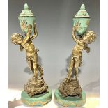 A pair of Italian gilt bronze figural garnitures, each modelled as a boy holding aloft an