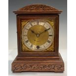 An oak cased mantel clock, Camerer Cuss and Co, London, Roman numerals on silvered chapter ring,