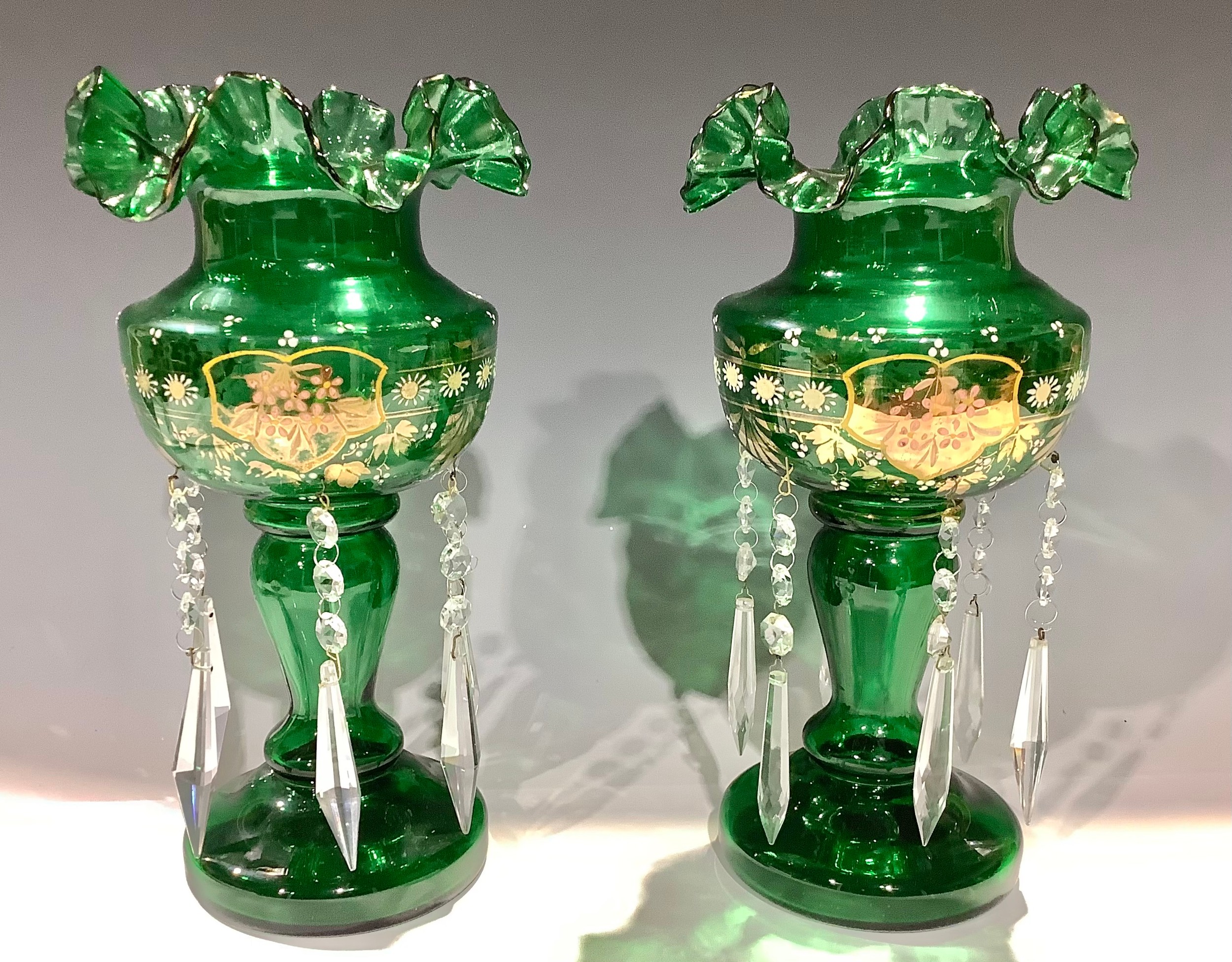 A pair of Victorian green glass lustres, enamelled and picked out in gilt, clear glass droplets,