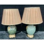 A pair of Chinese reproduction ovoid table lamps, lion mask faux ring handles, moss green ground