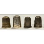 A silver thimble, Sheffield 1977; other silver coloured metal thimbles (4)