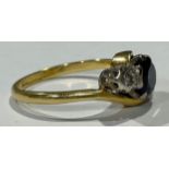 An 18ct gold diamond and sapphire three stone crossover ring, size P, marked 18ct, platinum bezel,