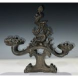 A Chinese dark patinated bronze stand, the central support cast with a fire breathing dragon,