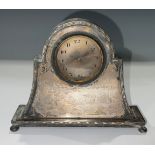 A George V Art Deco silver mantel alarm clock, eight day, arched case, rectangular base, bun feet,