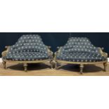 A pair of Victorian gilt ebonised conversation proportion drawing room chairs, 74cm high, 124cm