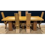 A contemporary hardwood dining table and chairs, the harlequin set of chairs in the manner of
