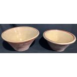 A large 19th century terracotta pancheon bowl, cream slip glazed interior, 46.5cm diameter; another,