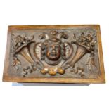 A late 19th century walnut jewellery box, the hinged cover carved in relief with a mask, c.1900,
