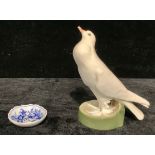 A Dresden model of a dove, standind, beak raised, circilar base, 19cm, impressed number 145, N133,