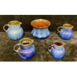 A graduated set of three Denby Danesby Ware Electric Blue jugs, the largest 18cm high; another