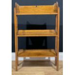 An Arts & Crafts oak bookcase, 88cm high, 55cm wide, 20cm deep, serial no. to verso, c.1910