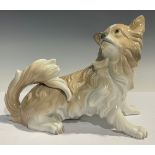 A Lladro model of a Pekingese Dog, impressed and blue printed mark to underside of base, 21cm high