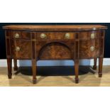 A George III mahogany serving table or sideboard, slightly oversailing top above an arrangement of