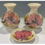A pair of Moorcroft Magnolia pattern ovoid bottle vases, 14cm, impressed and painted marks; a
