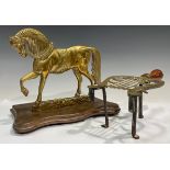 A Victorian brass hearth stand, modelled as a horse; a lyre shaped trivet (2)