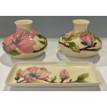 A pair of Moorcroft Magnolia pattern compressed ovoid vases, 10cm, impressed and painted marks; a