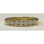 An 18ct gold seven stone diamond ring, channel set, size U/V, 4g, boxed