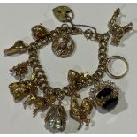 A 9ct gold double curb link charm bracelet, love heart padlock clasp, marked 375, including