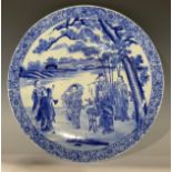 A large 19th century Chinese circular charger, decorated in underglaze blue with musicians at