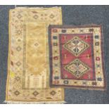 A Middle Eastern woollen rug or carpet, geometric shapes in tones of blue, red and ochre, 136cm x