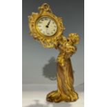 An Art Nouveau gilt metal timepiece, modelled as a maiden wearing long flowing dress, 23.5cm high