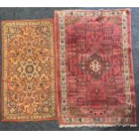 A Middle Eastern rectangular woollen rug or carpet, stylised geometric floral motifs, in tones of